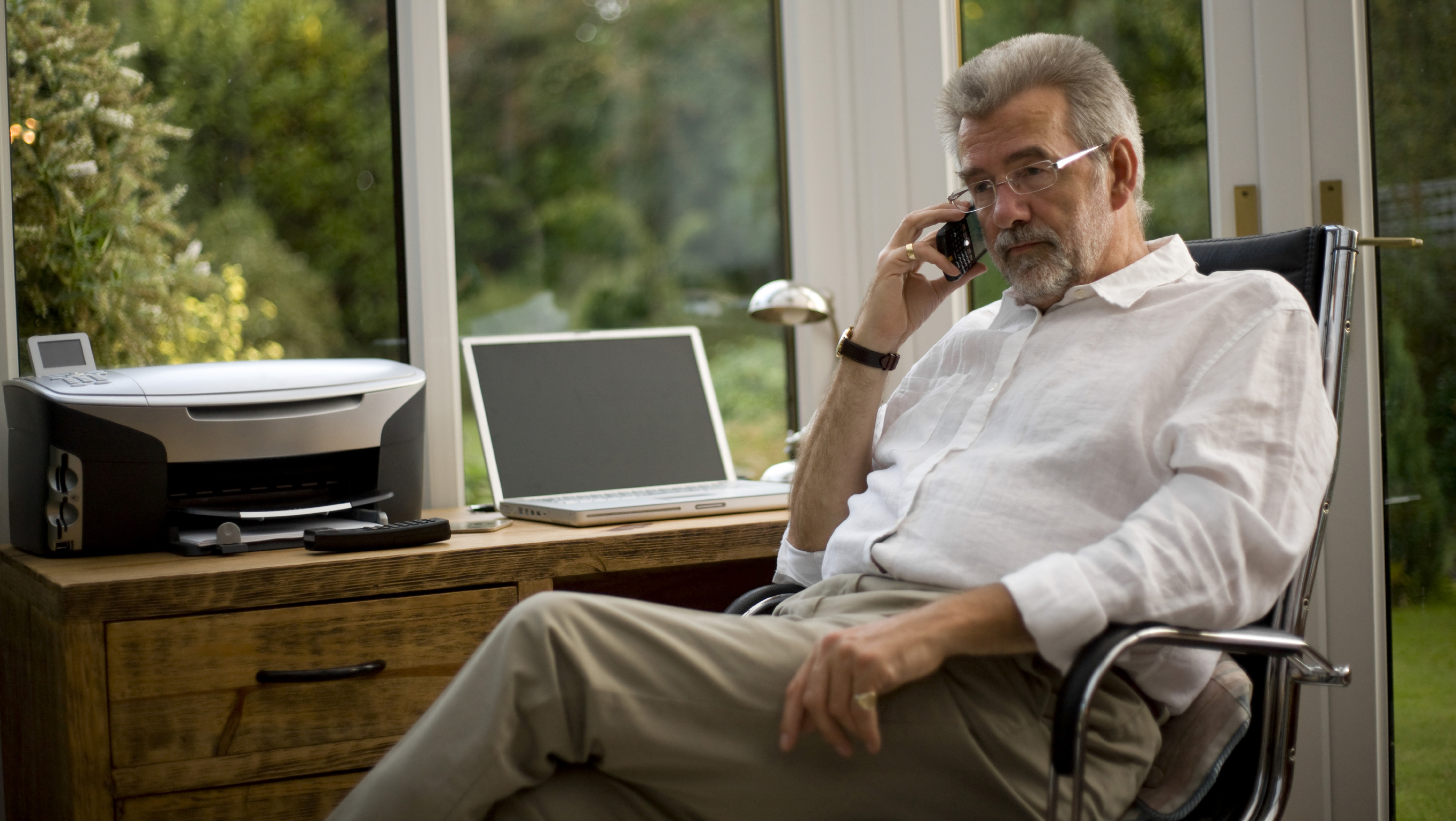 Male on the phone at a home office 